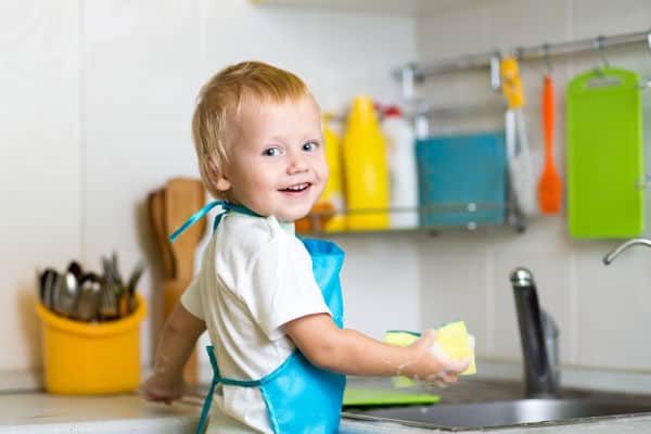 toddler helping out in the kitchen