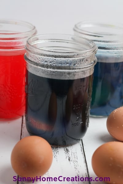 Eggs being dyed with food coloring