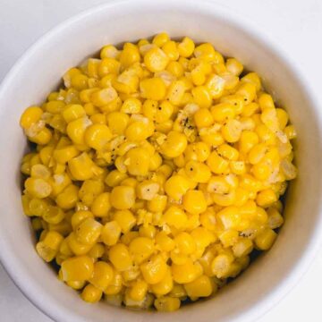 top down view of cooked canned corn in a bowl.