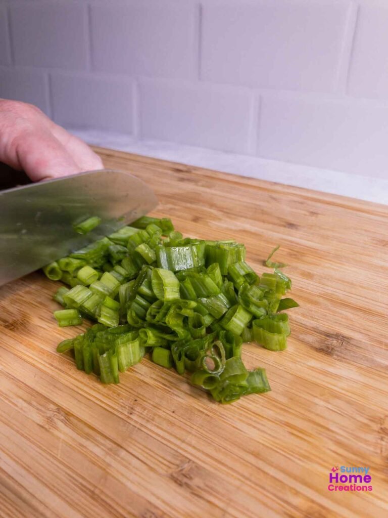 Cut green onions with a knife cutting further down the stem.