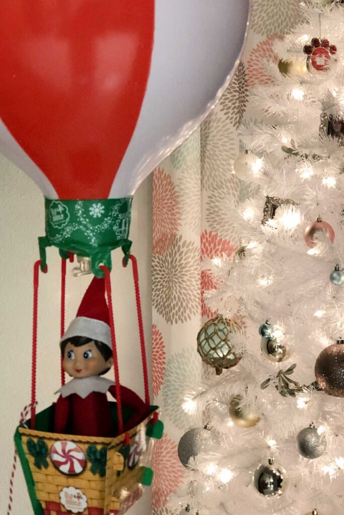 female elf on the shelf in a hot air balloon.
