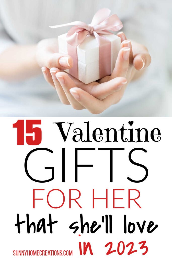 Pin image: top has a hand holding a white box with a pink ribbon and bow, bottom says "15 Valentine Gifts for her that she'll love in 2023".
