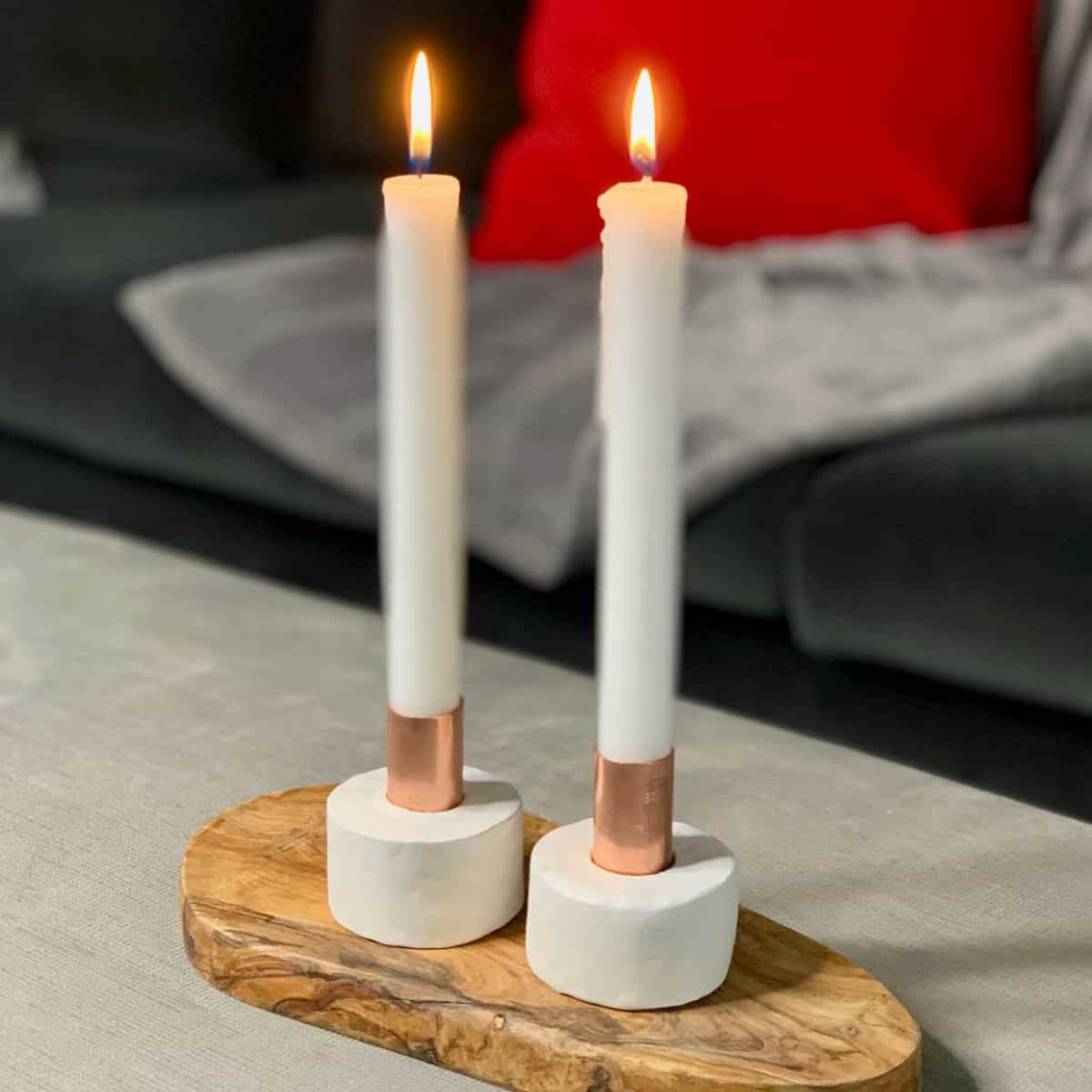2 candles in candlestick holders.