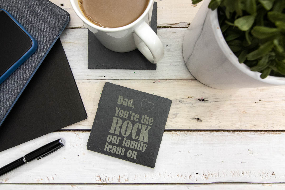 Engraved slate coaster with "Dad, You're the rock our family leans on" engraved in it